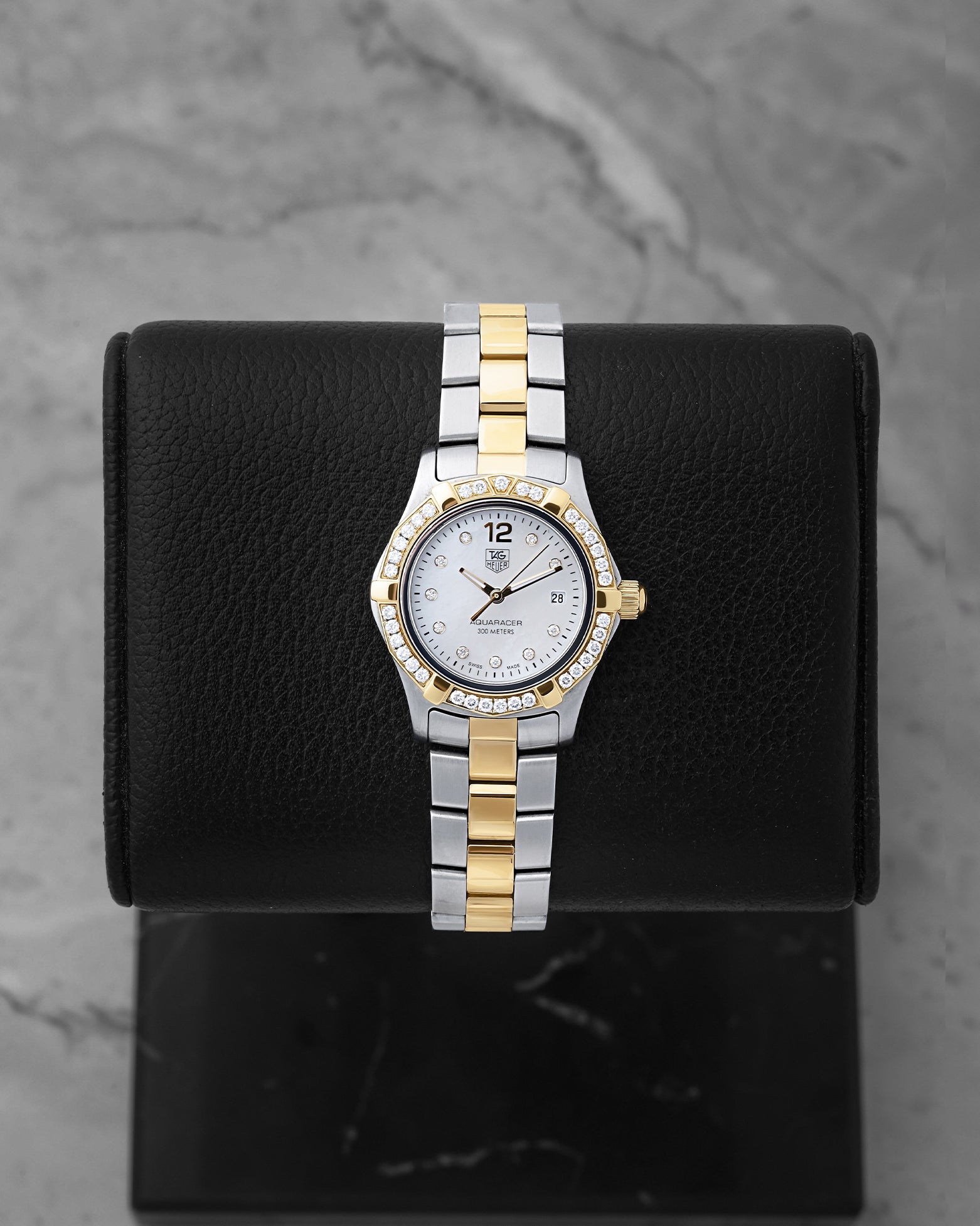 Preowned TAG Heuer Aquaracer 27mm WAF1450 ladies two-tone steel and yellow gold watch with factory diamond bezel and white Mother of Pearl dial at Noah's Fine Watches and Jewelry Dallas Texas