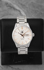A pre-owned TAG Heuer Carrera Calibre 5 Day-Date reference WAR201D featuring an opaline silver dial, rose gold plated baton indices, and a dual day-date window calendar at Noah's Fine Watches & Jewelry in Dallas