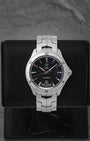 A preowned TAG Heuer Link Calibre 5 Day-Date reference WAT2010 showing its black dial with vertical tuxedo pinstripes and unique 6 o'clock day-date window at Noah's Fine Watches & Jewelry in Dallas