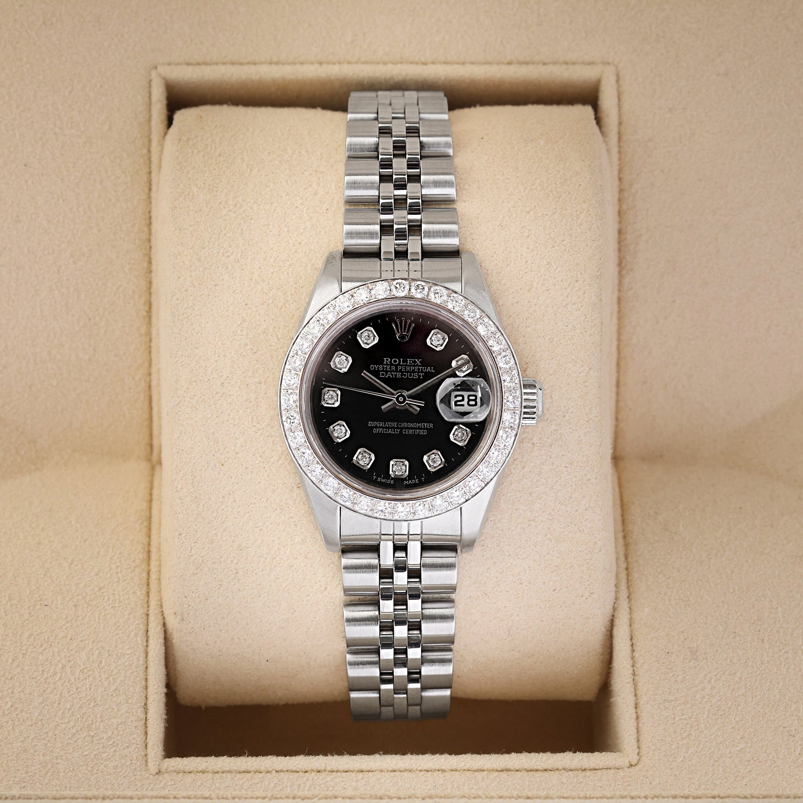 A ladies' pre owned 2000 Rolex Lady-Datejust reference 79174 featuring a custom black dial, diamond hour markers, and a custom diamond-set bezel inside its box at Noah's Fine Watches & Jewelry in Dallas