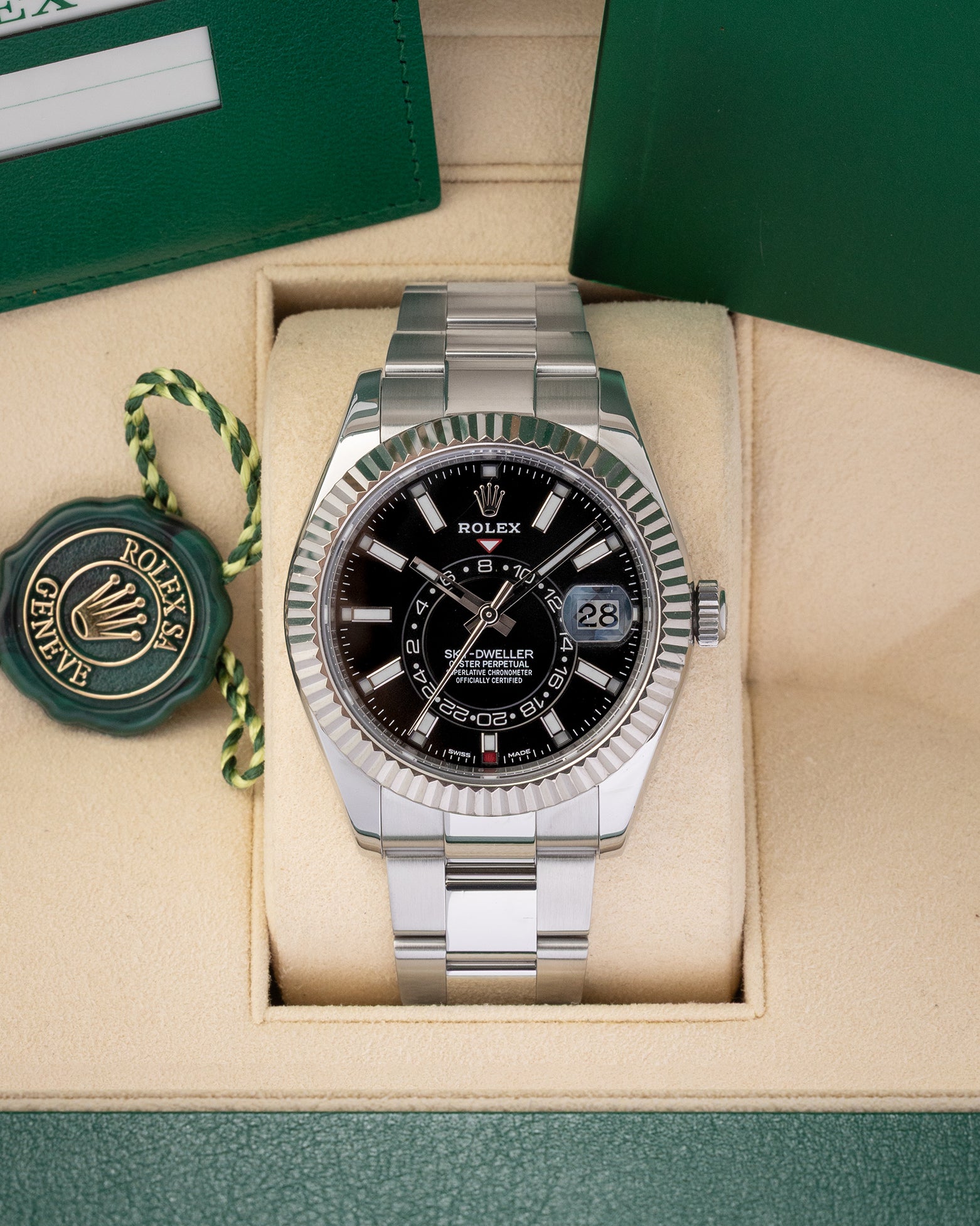 Preowned 2019 Rolex Sky-Dweller reference 326934 in Rolesor steel featuring a black sunray dial, off-center 24-hour GMT disc, and an 18k white gold fluted bezel inside its box at Noah's Fine Watches & Jewelry in Dallas