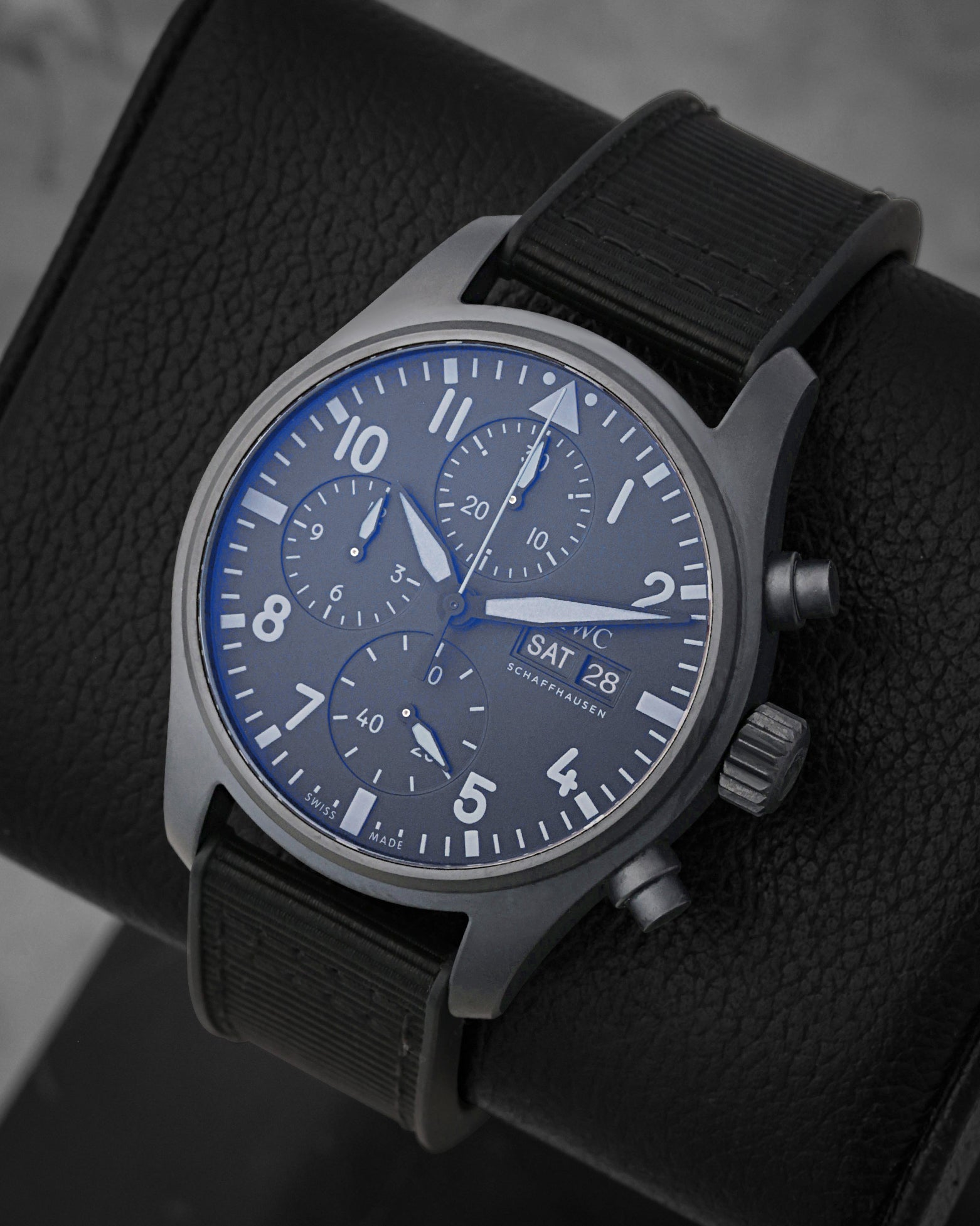 angled view of the 41mm IWC TOP GUN Ceratanium chronograph showing the double-register layout, day-date window, and blue anti-reflective crystal coating
