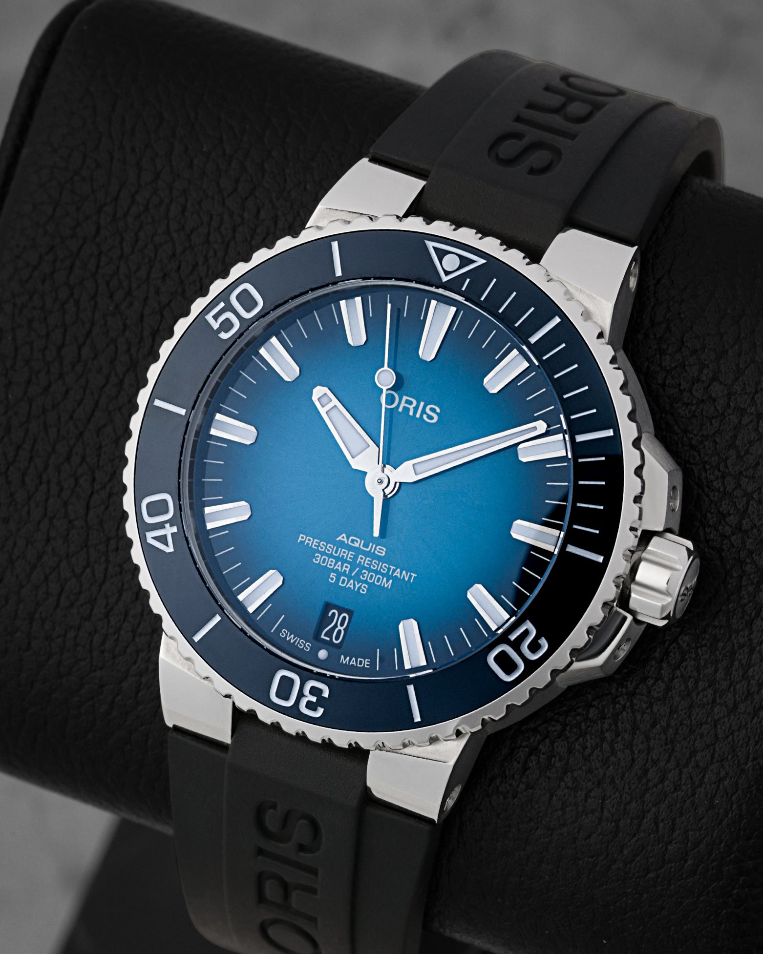 angled view of the 43.5mm stainless steel Oris Aquis dive watch showcasing its polished blue ceramic unidirectional rotating scratch-resistant bezel