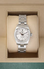 A ladies' pre owned Rolex Oyster Perpetual 26 reference 176200 featuring a silver sunburst dial, luminous baton hour markers, and a smooth domed bezel inside its box at Noah's Fine Watches & Jewelry in Dallas