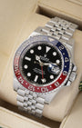 Three-quarter angled view of the 40mm Rolex Pepsi GMT-Master II showcasing the black index dial, red GMT hand, and iconic five-link stainless steel Jubilee bracelet