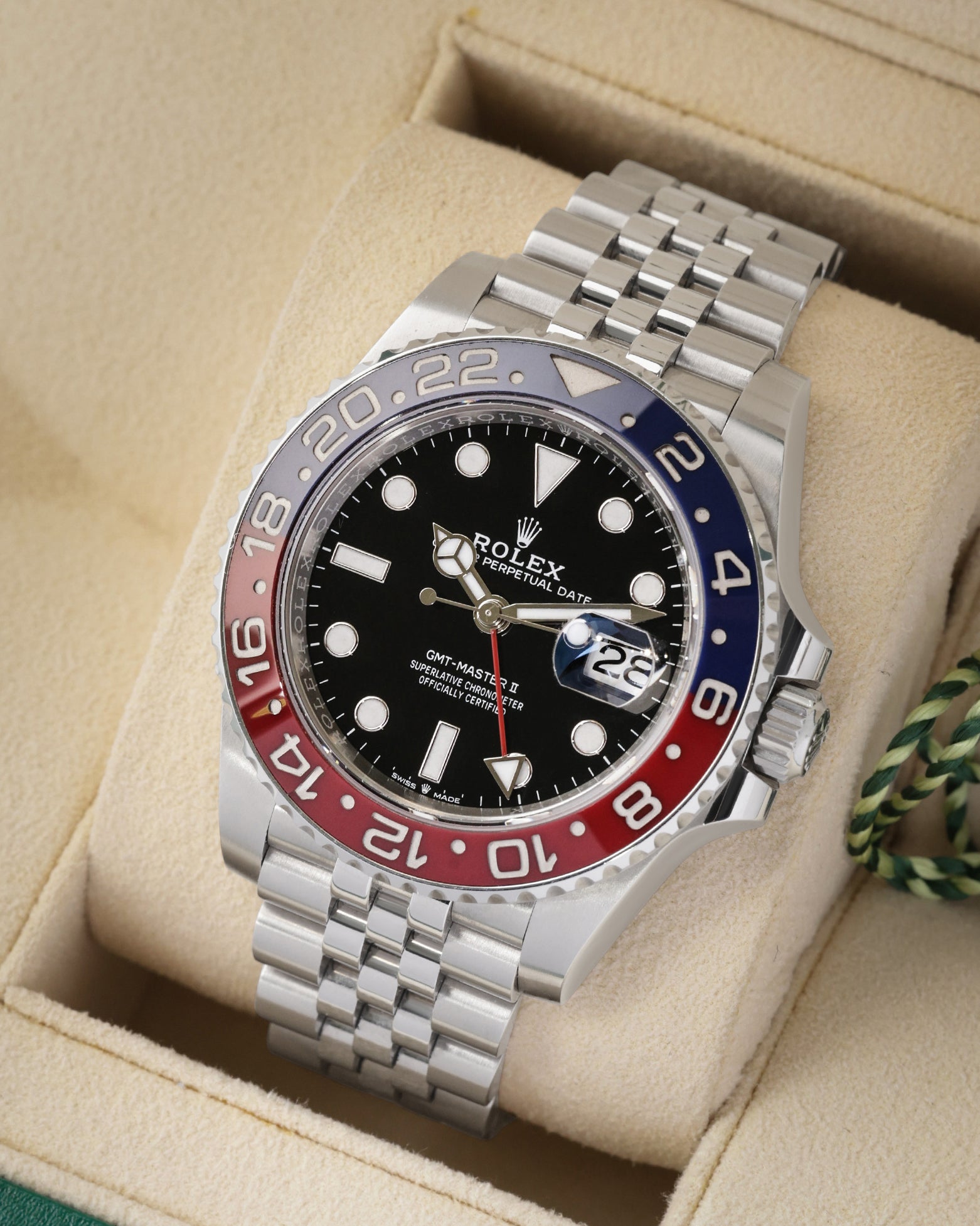 Three-quarter angled view of the 40mm Rolex Pepsi GMT-Master II showcasing the black index dial, red GMT hand, and iconic five-link stainless steel Jubilee bracelet