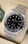 Angled view of the 41mm Oystersteel case, glossy black dial, and unidirectional Cerachrom ceramic dive bezel on a Rolex Submariner 124060