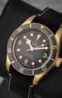 angled view of the 43mm aluminum-bronze alloy case on the Tudor Black Bay showcasing the snowflake hands and Arabic numerals at 3, 6, and 9