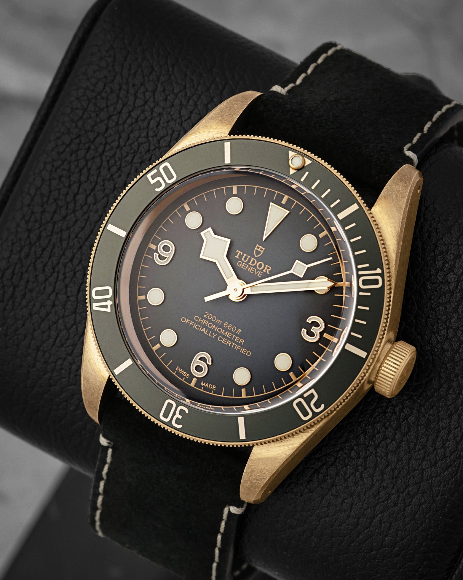angled view of the 43mm aluminum-bronze alloy case on the Tudor Black Bay showcasing the snowflake hands and Arabic numerals at 3, 6, and 9