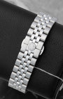 A five-link stainless steel watch bracelet with an integrated butterfly folding clasp showing the circular RW logo stamp