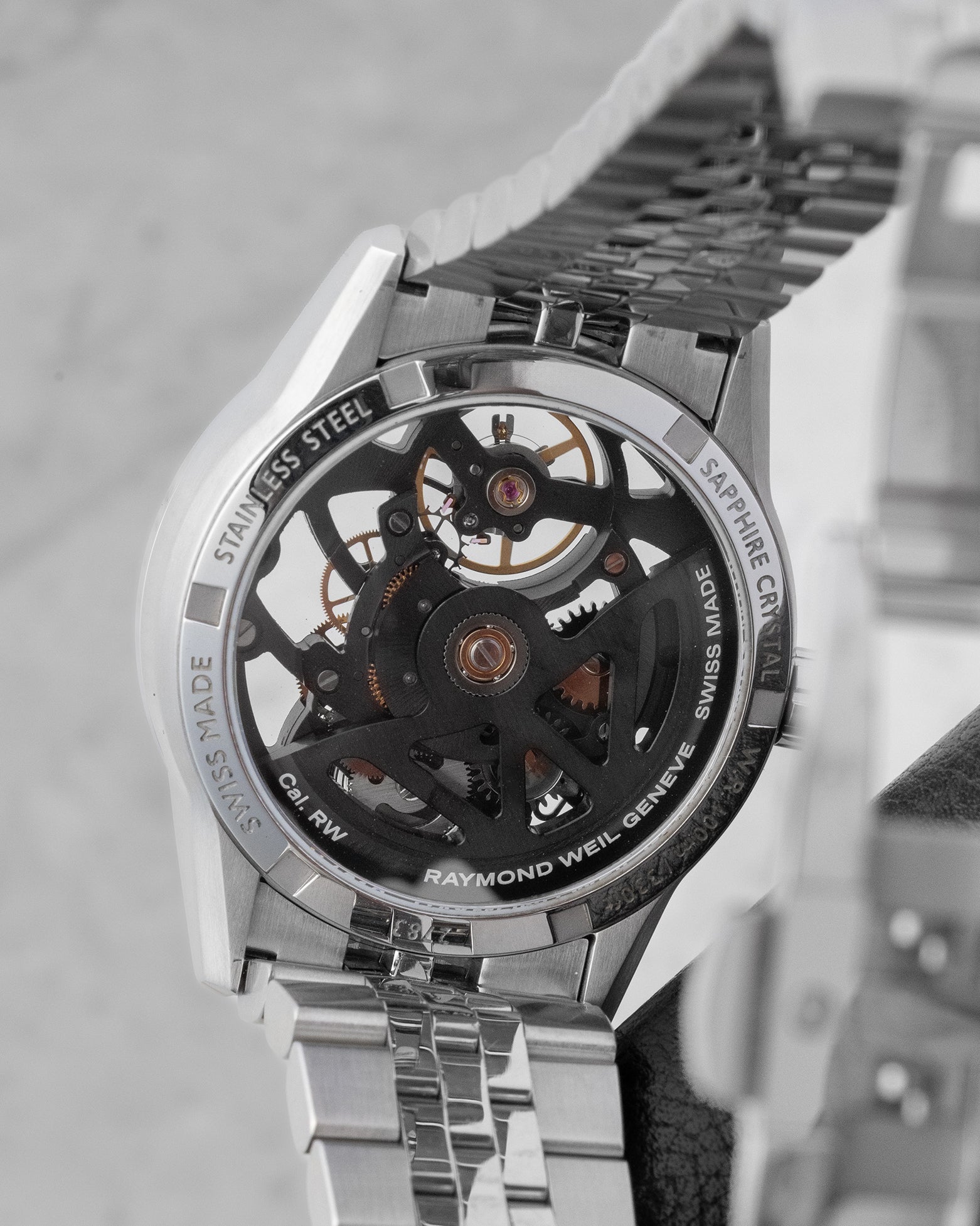 Transparent sapphire exhibition caseback revealing the black ruthenium-coated movement and signature W-shaped oscillating rotor