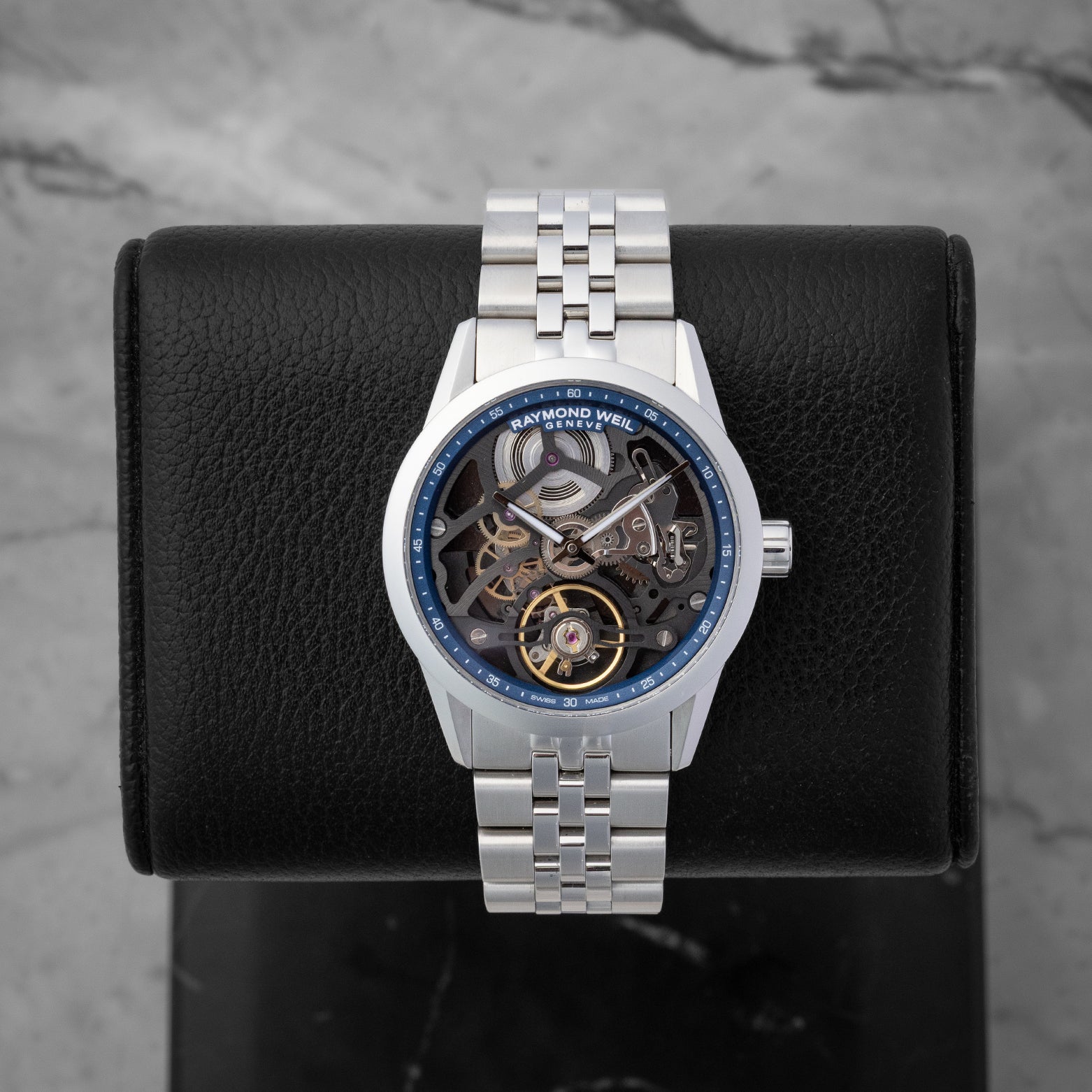 Raymond Weil Freelancer Skeleton 38mm watch featuring a blue chapter ring anthracite openwork bridge and an exposed balance wheel