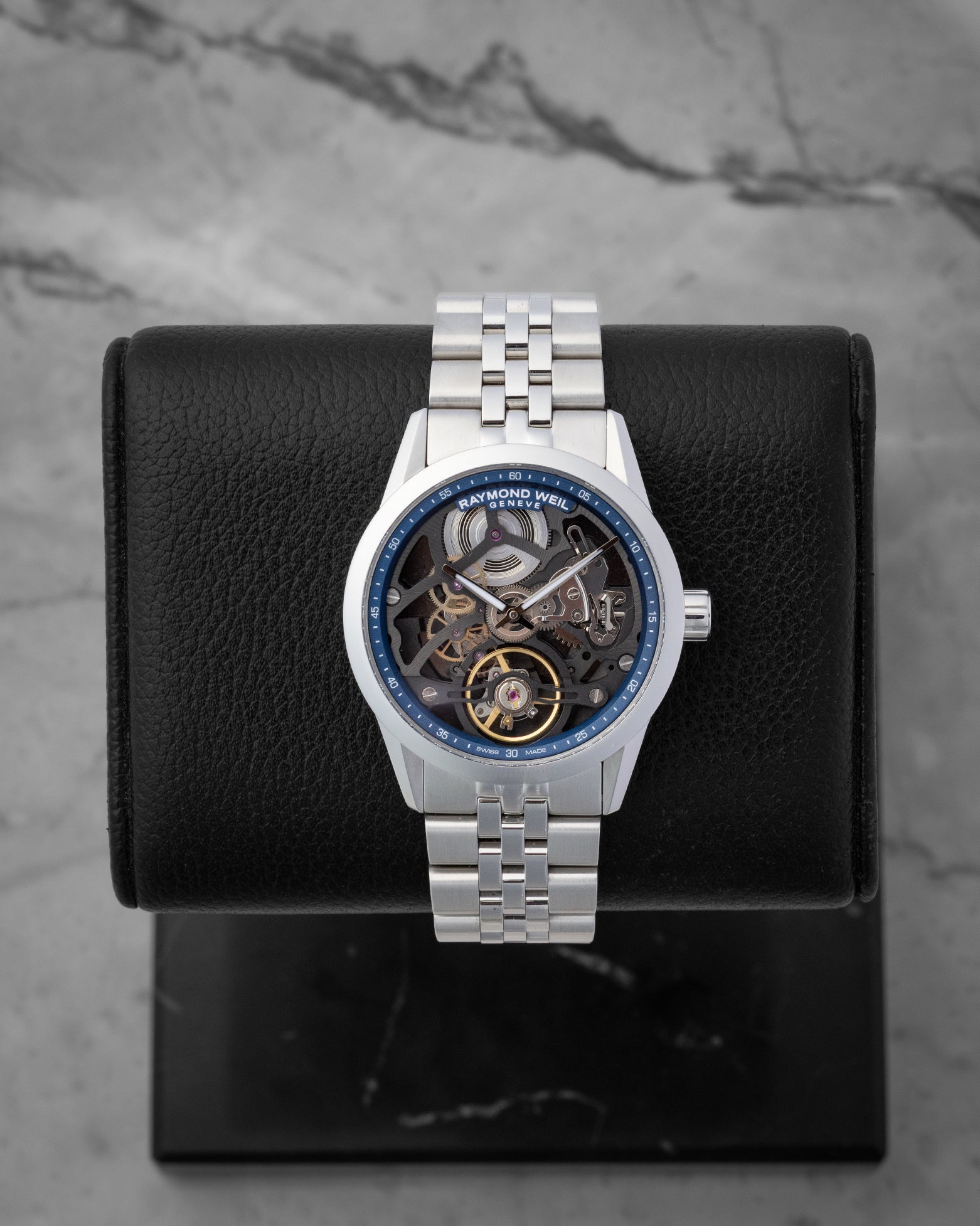 Raymond Weil Freelancer Skeleton 38mm watch featuring a blue chapter ring anthracite openwork bridge and an exposed balance wheel