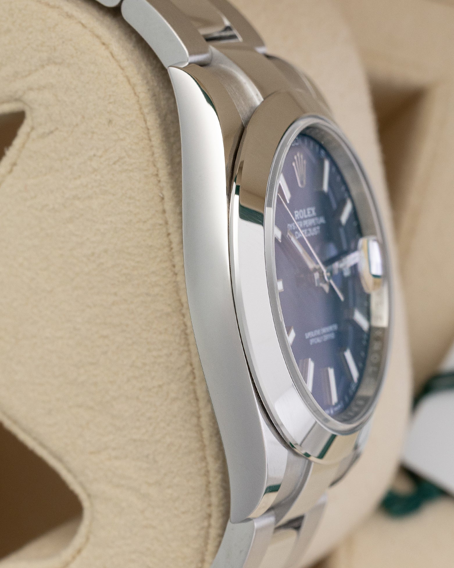 left non-crown side profile view of a stainless steel Rolex Datejust 126300 highlighting its high-polish finish and curved lugs