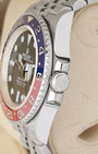 Side profile focus on the Oystersteel case architecture and the protected Triplock waterproof screw-down winding crown of the Rolex 126710BLRO