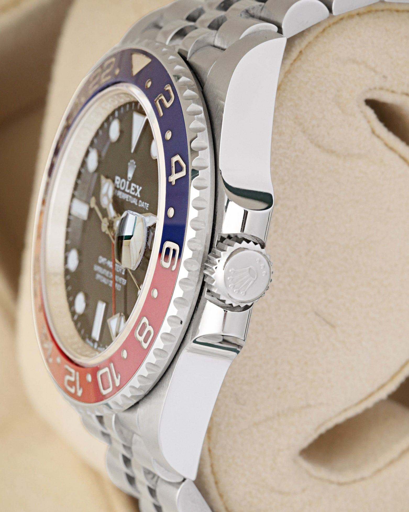 Side profile focus on the Oystersteel case architecture and the protected Triplock waterproof screw-down winding crown of the Rolex 126710BLRO