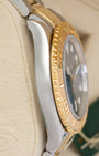 left non-crown side profile view of a stainless steel and yellow gold Rolex Yacht-Master case showcasing its polished finish and curved lugs