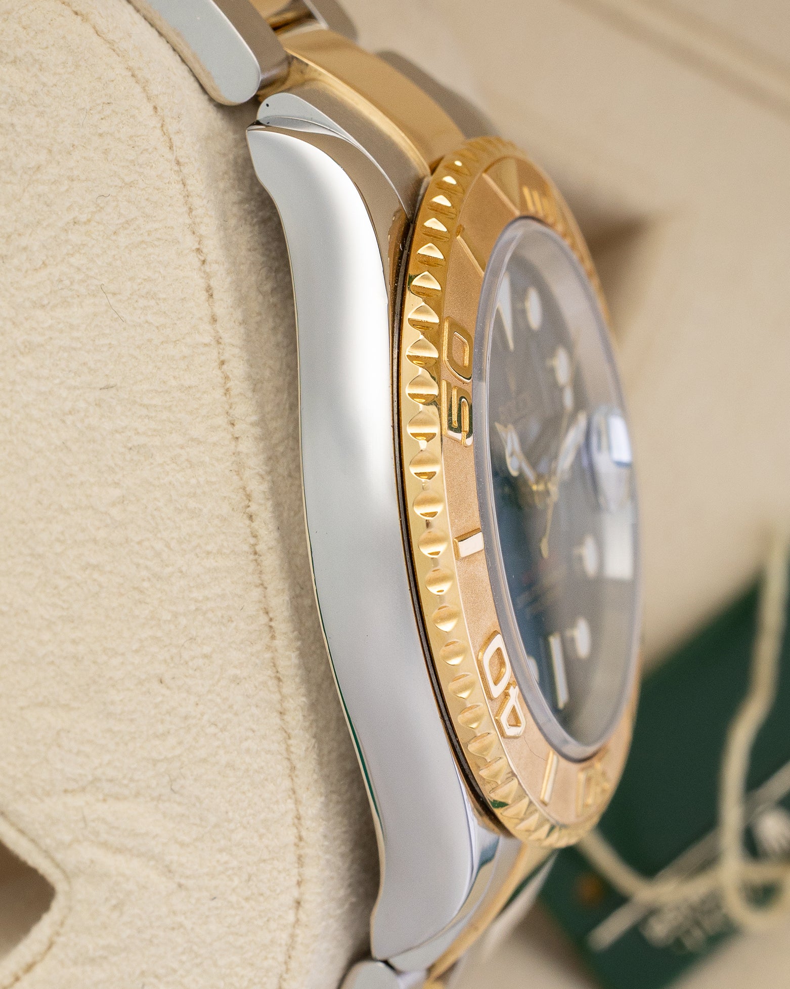 left non-crown side profile view of a stainless steel and yellow gold Rolex Yacht-Master case showcasing its polished finish and curved lugs
