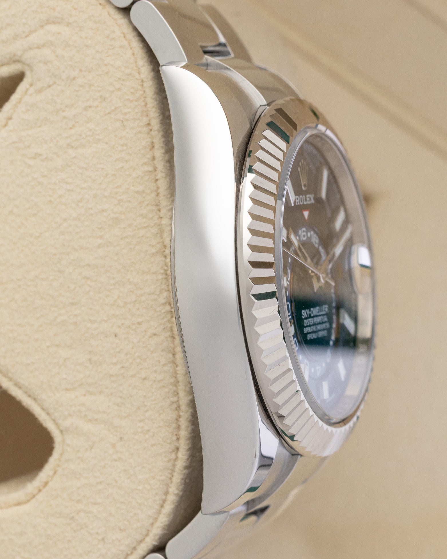 left non-crown side profile view of a stainless steel Rolex Sky-Dweller case showcasing its high-polish finish and substantial lugs