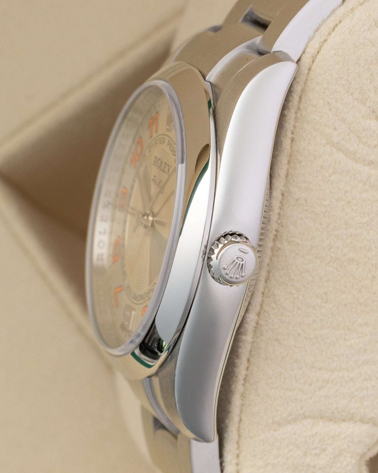 Side profile view showing the stainless steel smooth bezel, winding crown, and case of a Rolex Air-King 114200