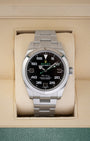 Rolex Air-King 40 reference 116900 stainless steel luxury watch featuring a black dial with green accents, resting inside its presentation box