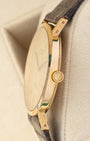 Ultra-thin side profile view showing the 18k yellow gold winding crown and slim case design of a vintage Rolex Cellini 4112