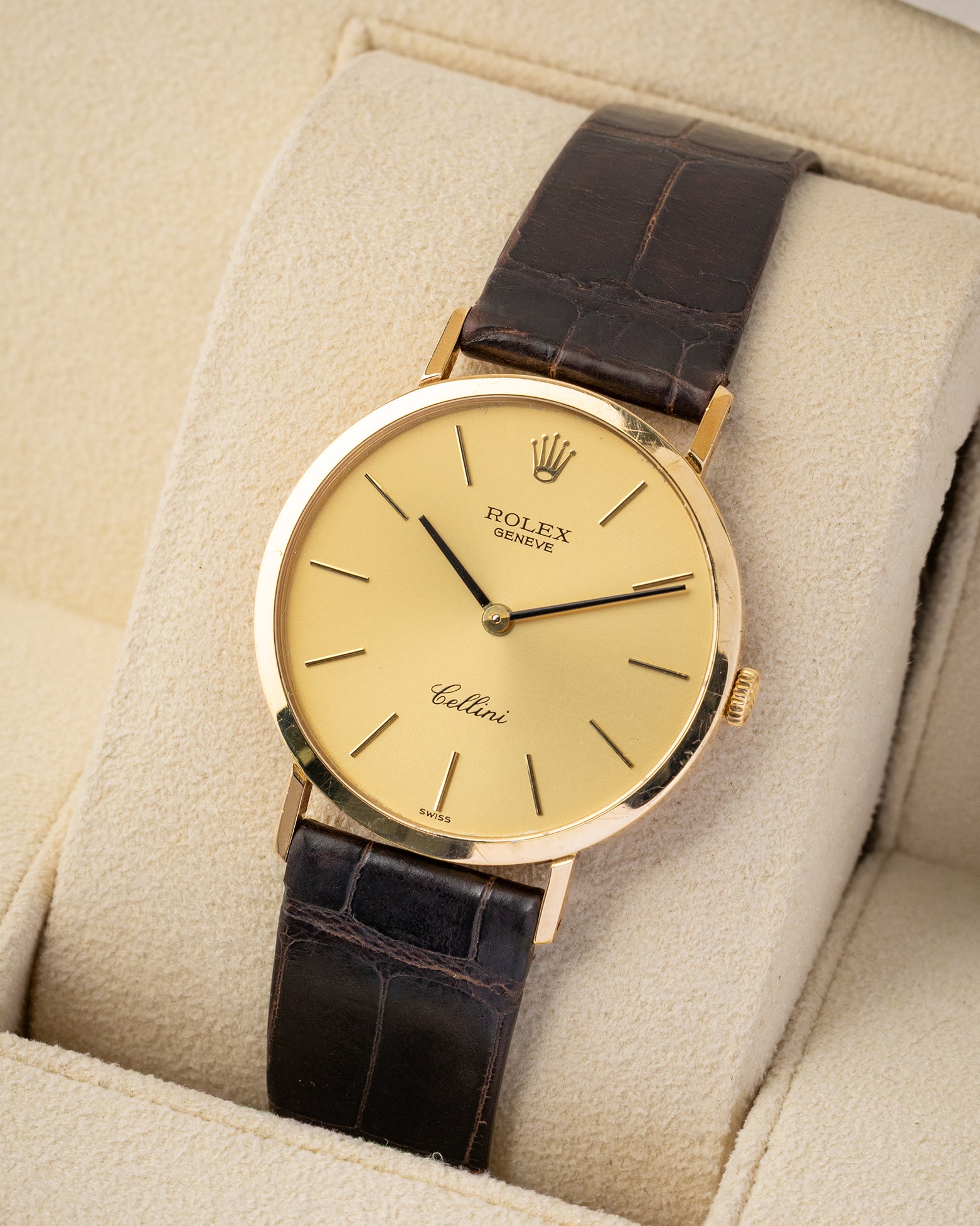 Angled front view of pre-owned 1980 Rolex Cellini 4112 dress watch featuring an 18k yellow gold case, champagne dial, and brown alligator leather strap