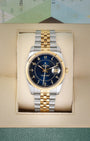 Front view of a pre-owned 2006 Rolex Datejust 36 Ref 116233 featuring an aftermarket blue boiler gauge dial with gold Arabic numerals, available at Noahs Fine Watches and Jewelry Dallas