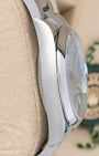 left-side case profile view of a pre-owned 36mm stainless steel Rolex Datejust Oyster case resting on a presentation cushion