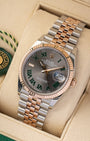 studio portrait of the 36mm luxury watch case showcasing its 18k Everose gold fluted bezel and polished rose gold center Jubilee links on a beige cushion