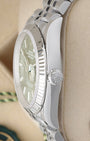 Side profile view of a stainless steel Rolex 126234 case showing the crisp 18k white gold fluted bezel and signed screw-down crown