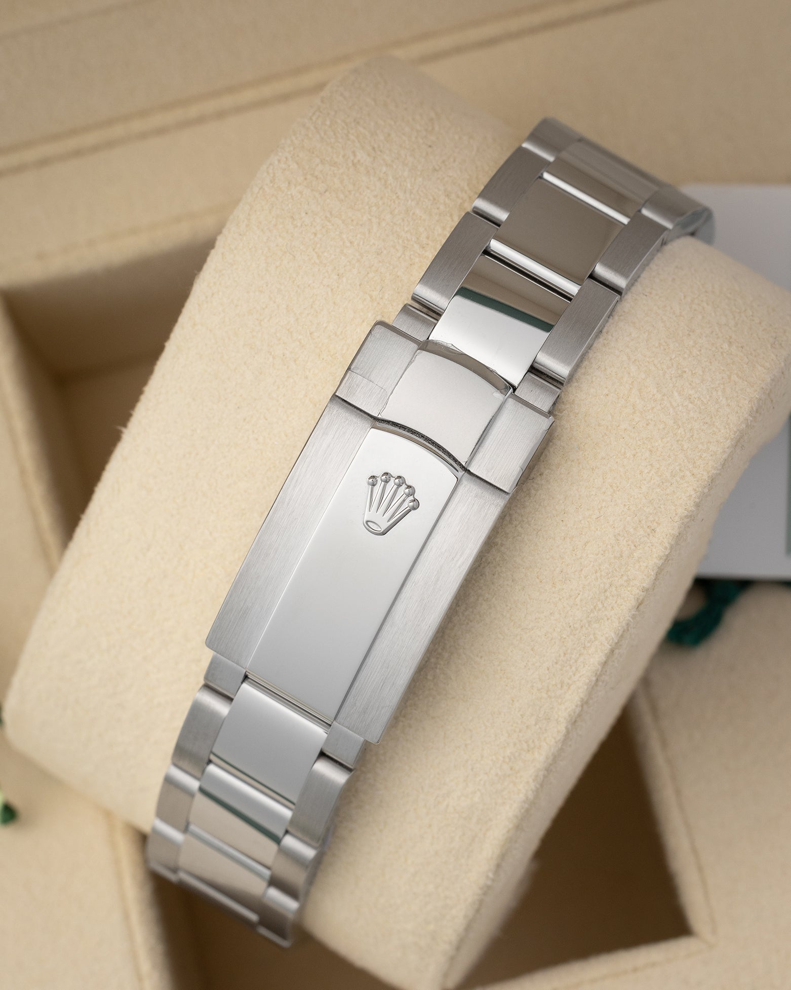 top-down snapshot of the brushed stainless steel three-link Oyster bracelet showing the folding Oysterclasp with an embossed coronet