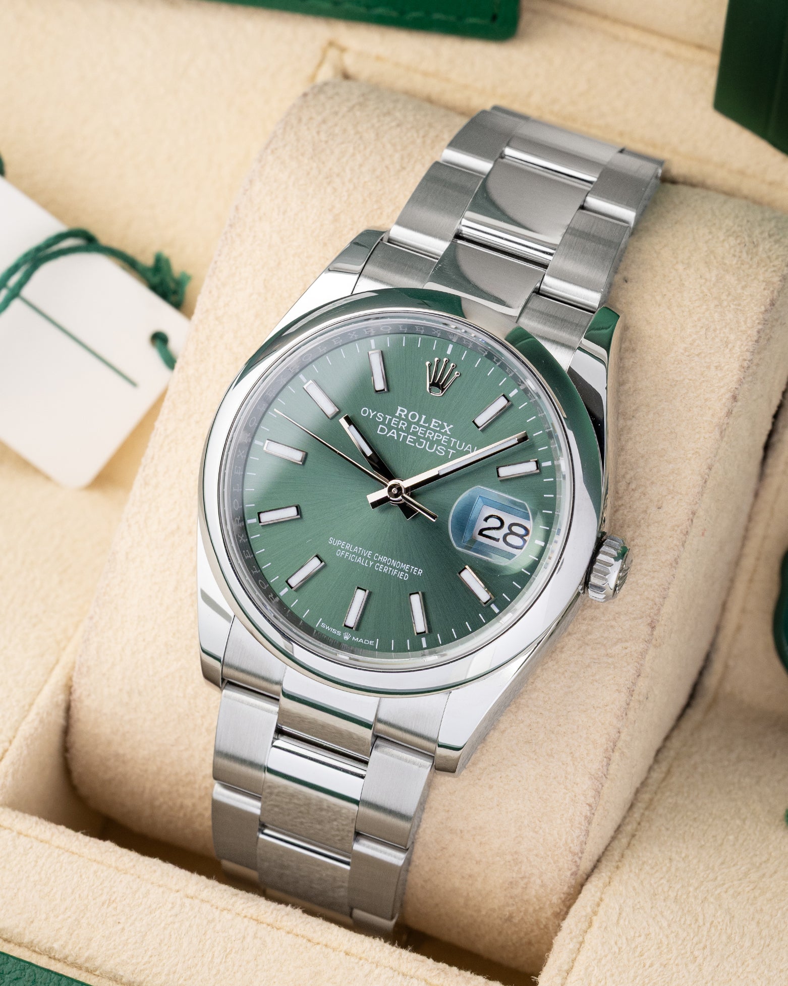 angled profile view of a pre-owned 2024 Rolex Datejust 36 reference 126200 showcasing the mint green index dial and stainless steel Oyster bracelet