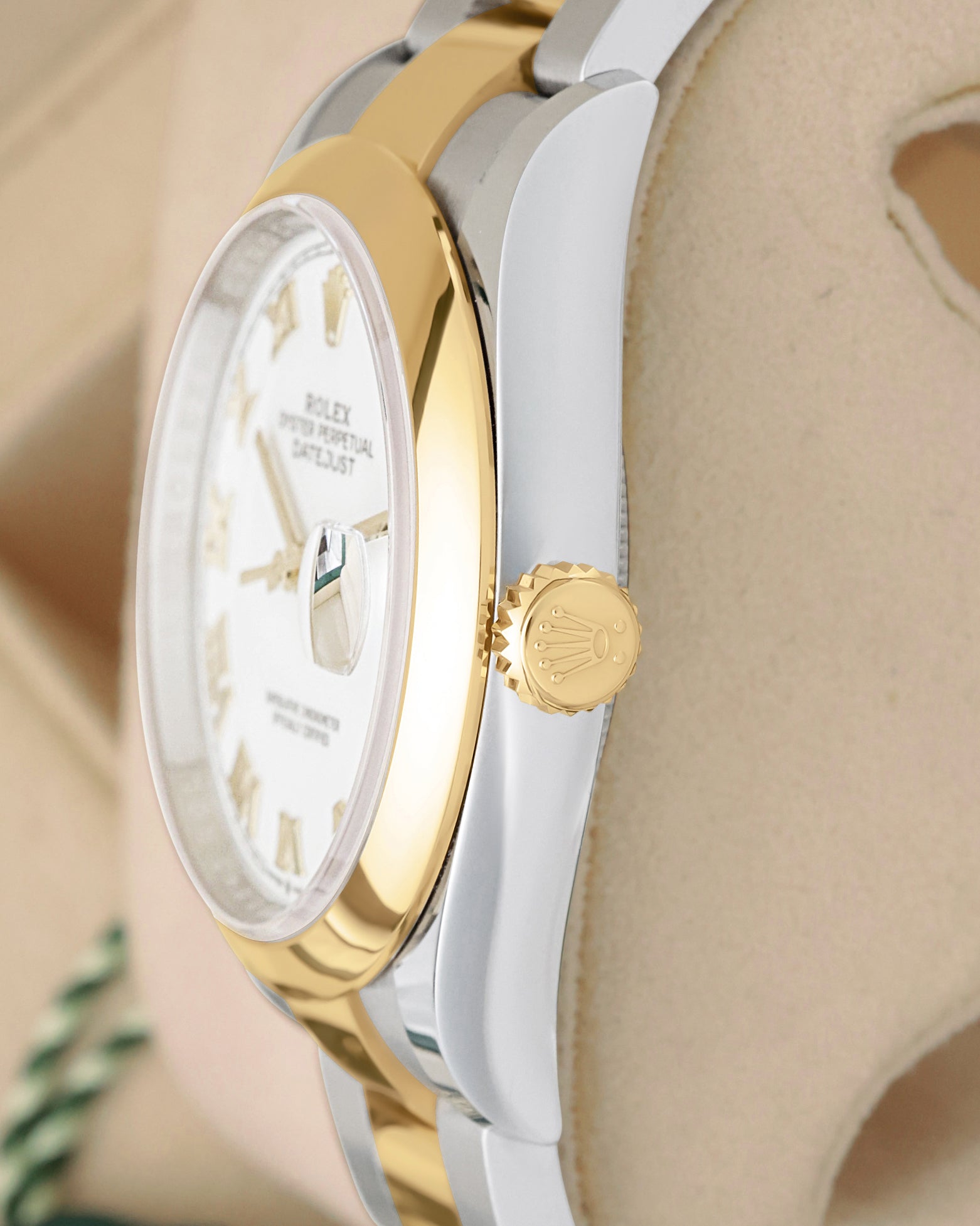 Side view close-up of the 18k yellow gold Twinlock screw-down crown and smooth domed bezel on Rolex Datejust 126203