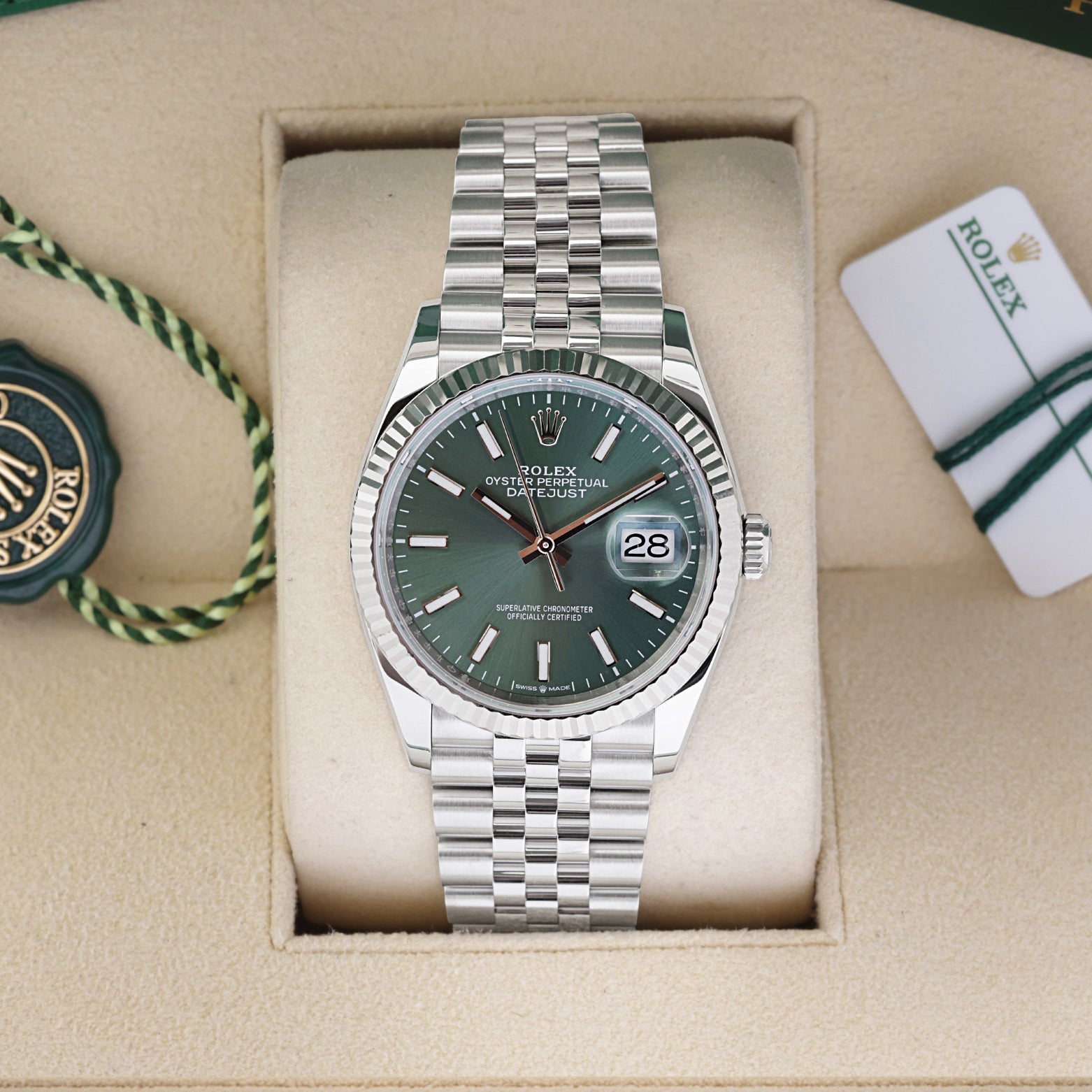 Rolex Datejust 36 126234 stainless steel watch featuring a mint green stick dial and 18k white gold fluted bezel inside its box