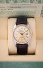 1986 vintage Rolex Datejust 36 reference 16013 featuring a champagne linen dial, 18k yellow gold fluted bezel, and dark brown leather strap inside presentation box.