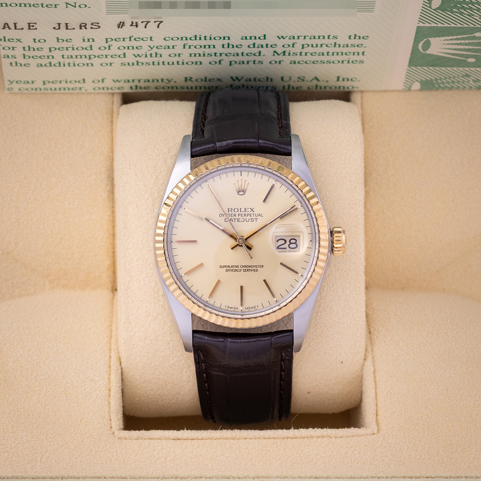 1986 vintage Rolex Datejust 36 reference 16013 featuring a champagne linen dial, 18k yellow gold fluted bezel, and dark brown leather strap inside presentation box.