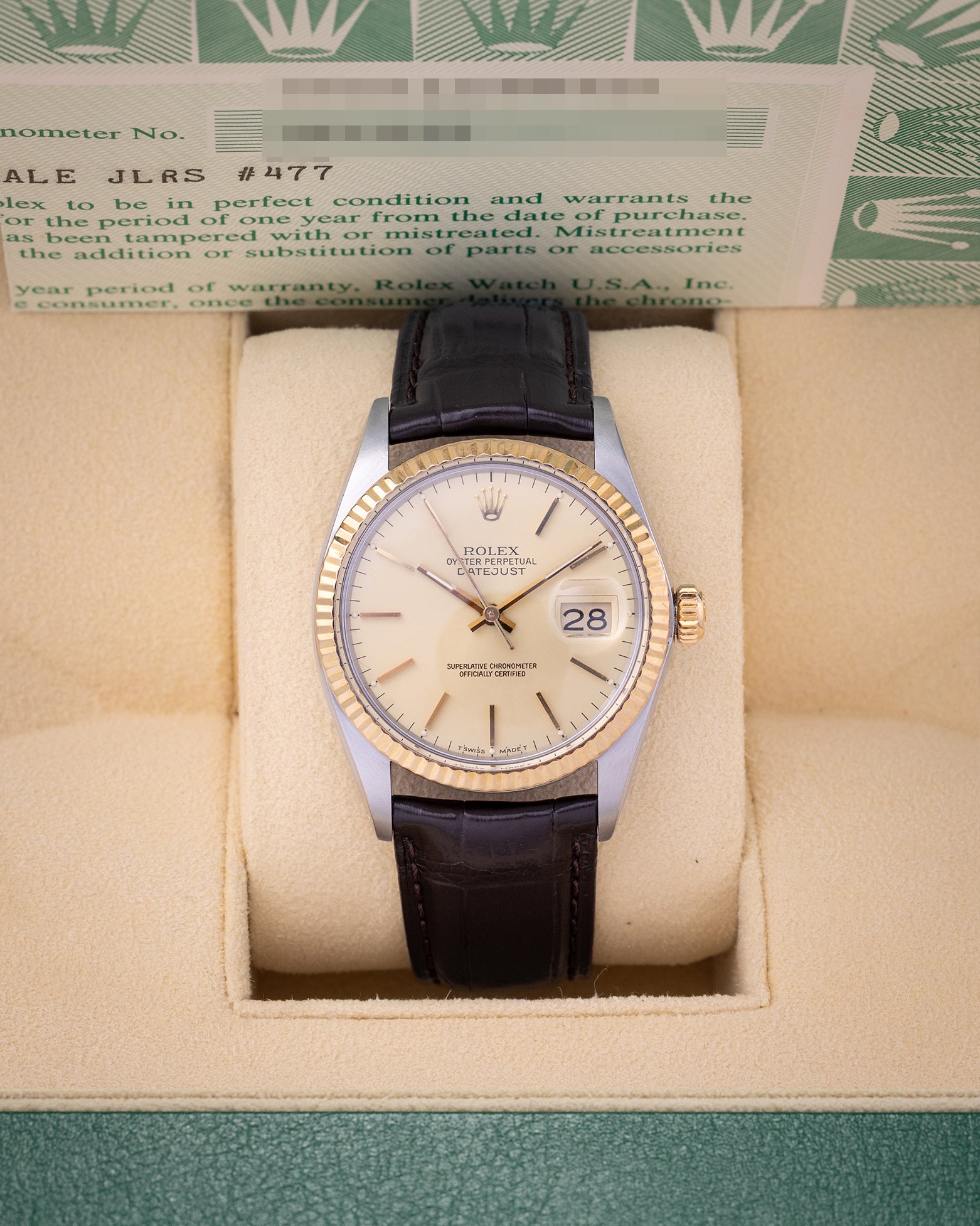 1986 vintage Rolex Datejust 36 reference 16013 featuring a champagne linen dial, 18k yellow gold fluted bezel, and dark brown leather strap inside presentation box.