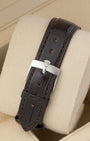 Dark brown textured leather strap with silver pin buckle clasp mounted on a watch pillow for the 1986 Rolex Datejust 36.
