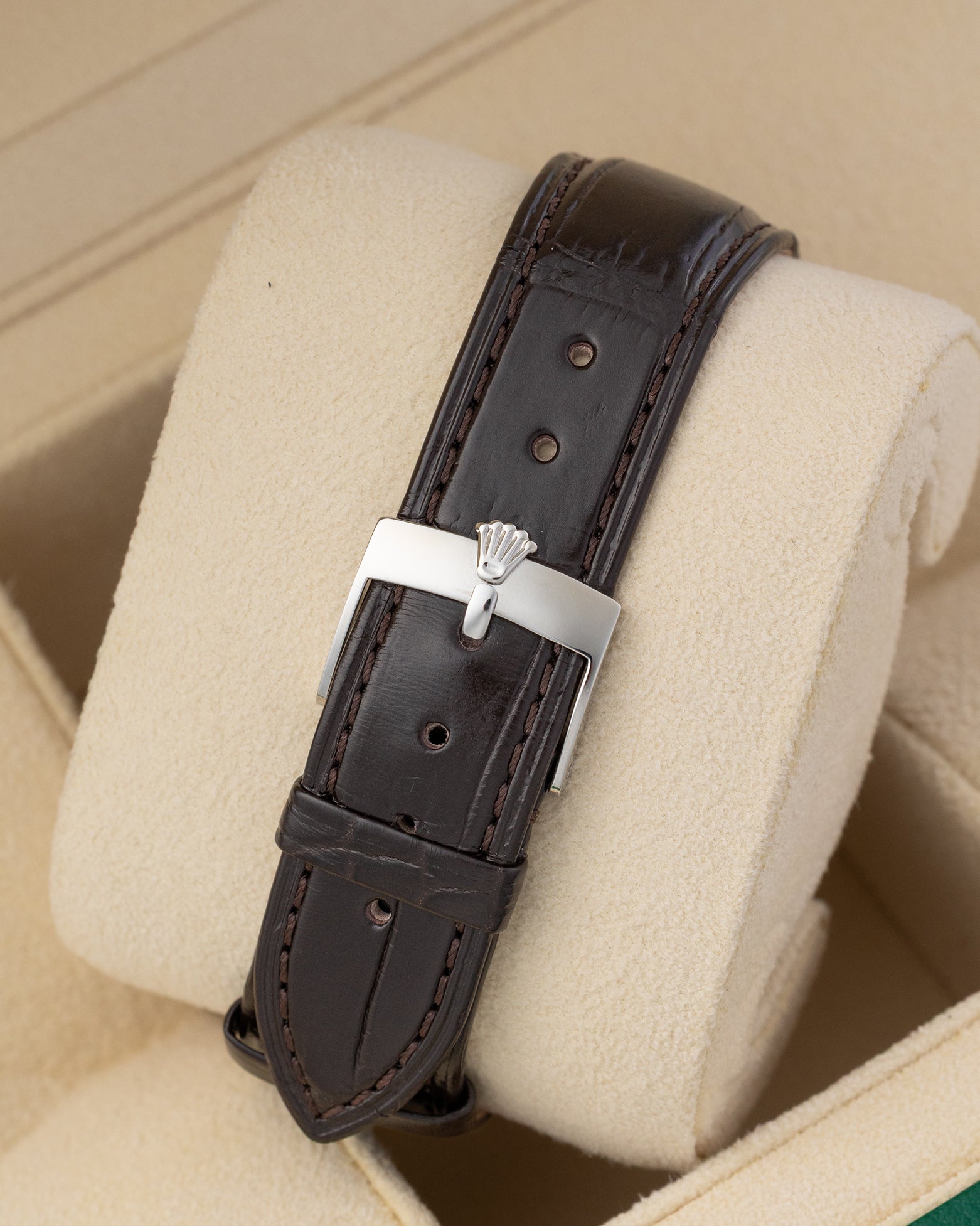 Dark brown textured leather strap with silver pin buckle clasp mounted on a watch pillow for the 1986 Rolex Datejust 36.