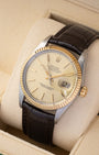 Angled view of a 1986 vintage Rolex Datejust 36mm 16013 showing the sunburst champagne dial, cyclops date display, and stainless steel case.