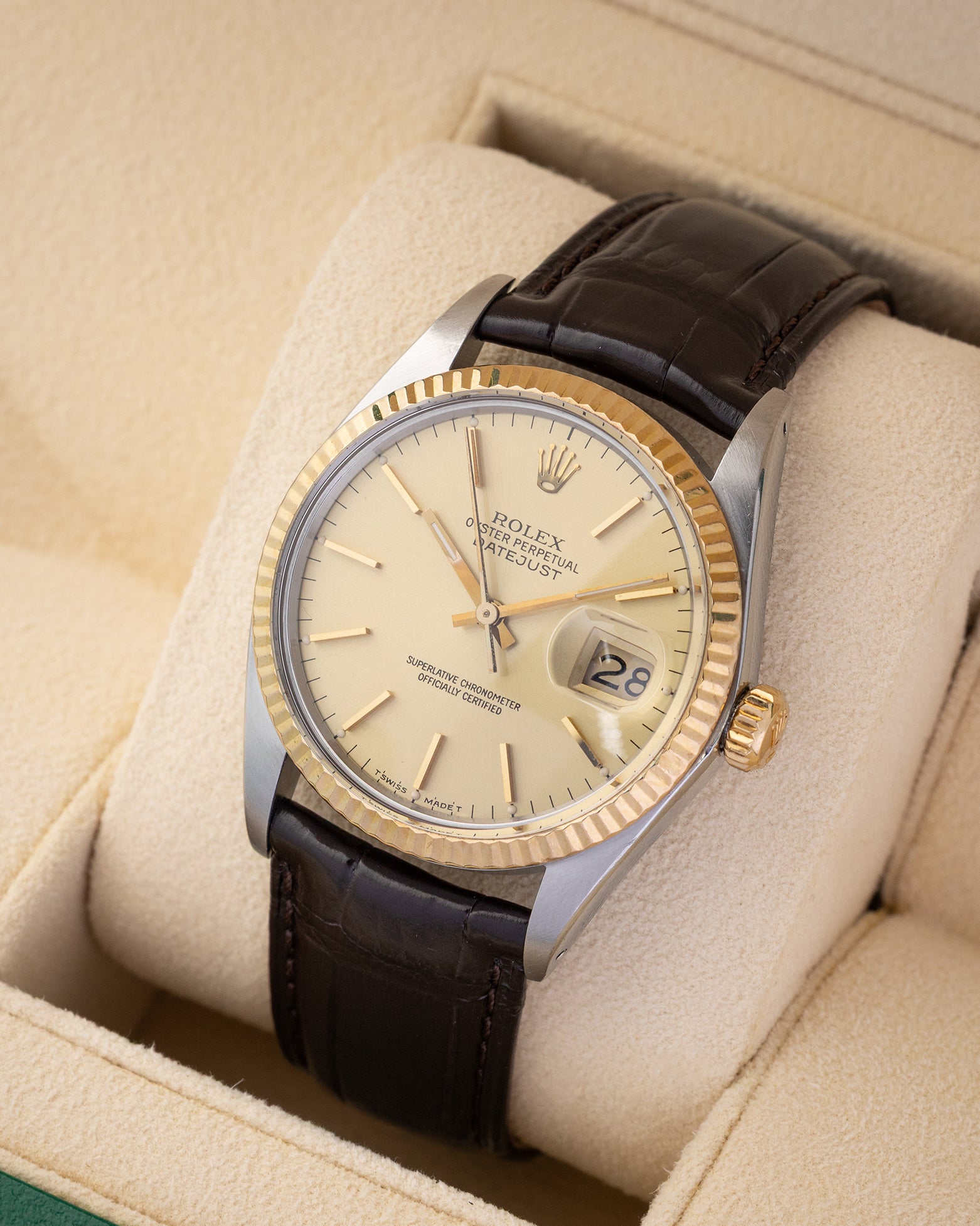 Angled view of a 1986 vintage Rolex Datejust 36mm 16013 showing the sunburst champagne dial, cyclops date display, and stainless steel case.