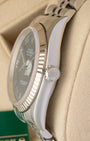 Close-up right profile view of the watch head highlighting the flat sapphire crystal with a magnified Cyclops window and the fluted steel Twinlock screw-down winding crown