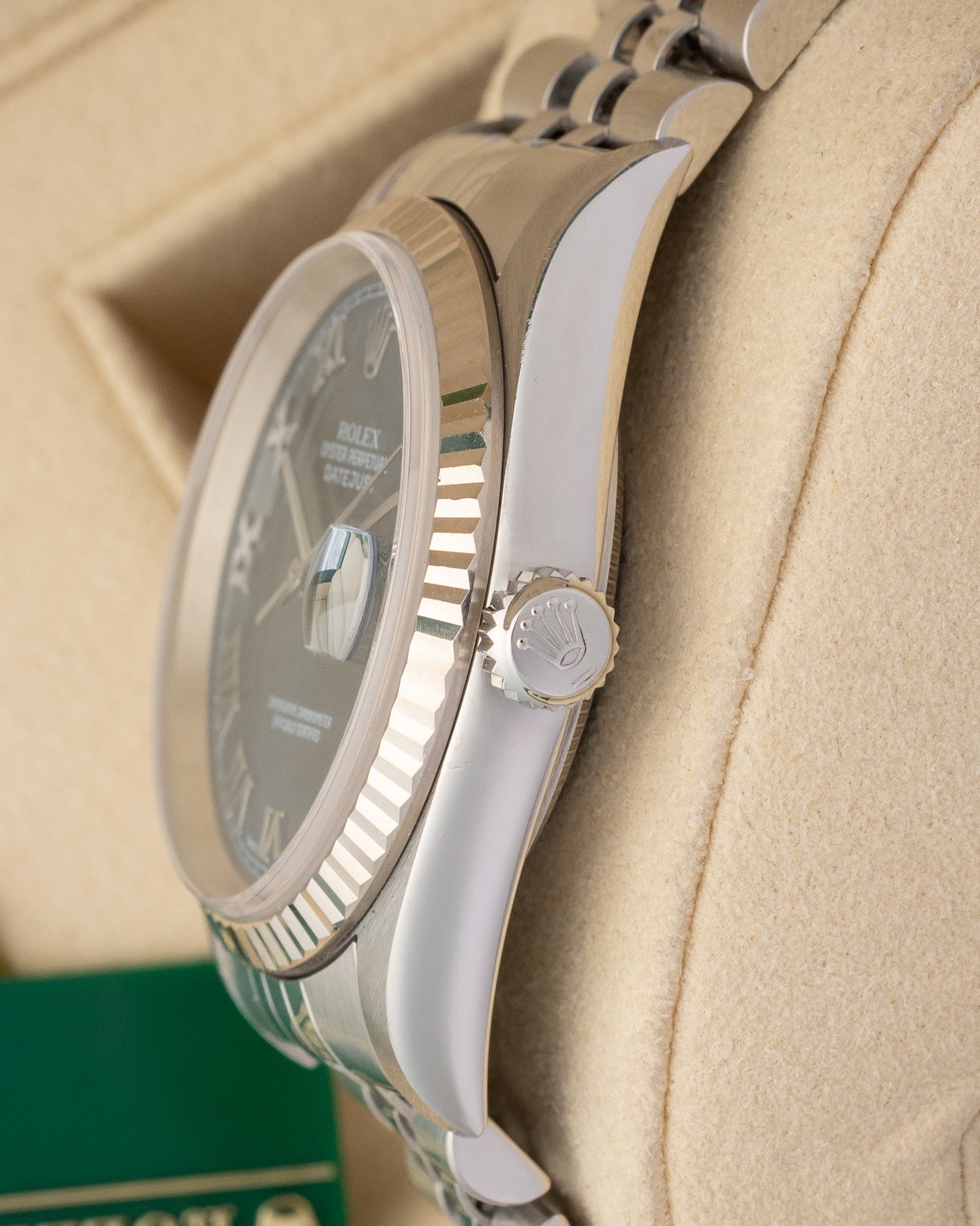 Close-up right profile view of the watch head highlighting the flat sapphire crystal with a magnified Cyclops window and the fluted steel Twinlock screw-down winding crown