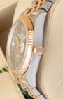 Close-up right profile view of the watch head highlighting the sharp coin-edge fluted bezel details, flat sapphire crystal with Cyclops lens, and the 18k Everose gold Twinlock crown