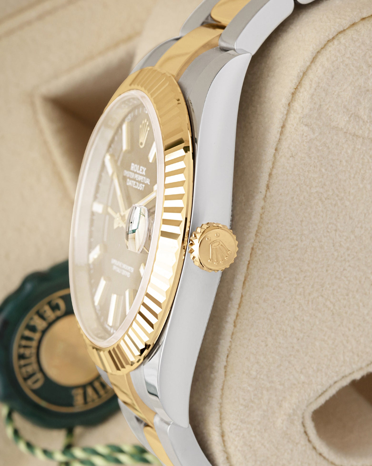 Close-up of the 18k yellow gold Twinlock winding crown and fluted bezel on a Rolex Datejust 41