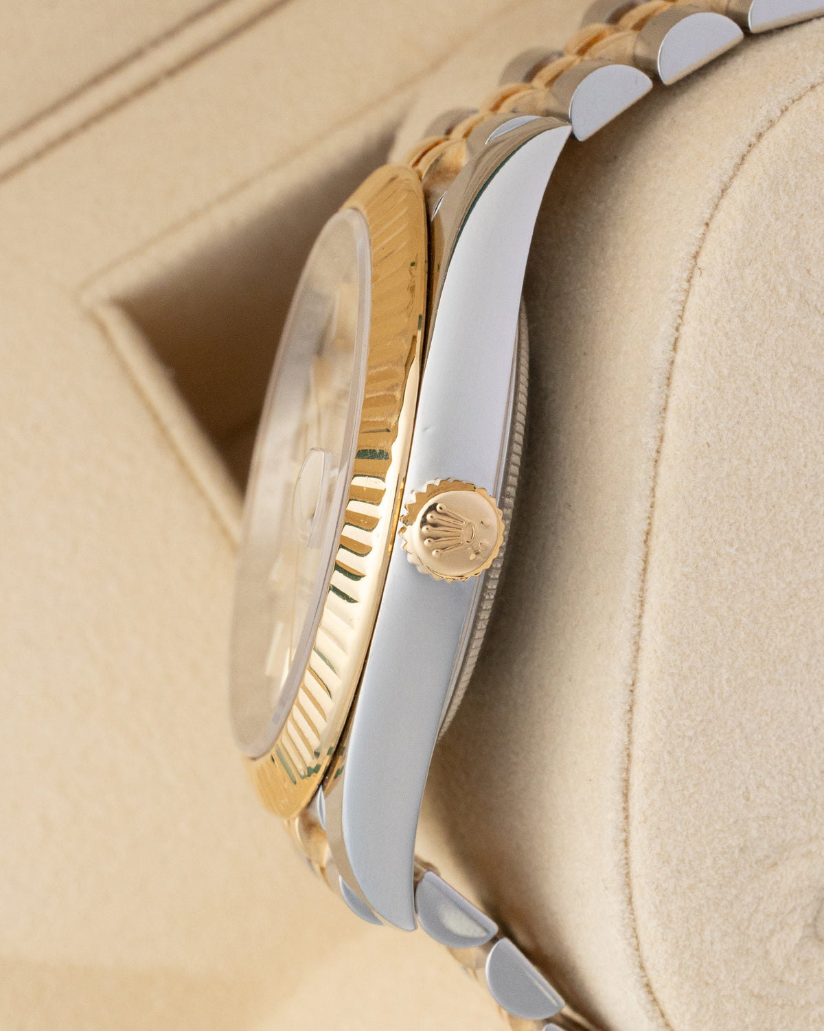 Side profile of Rolex Datejust 41 126333 showing 18k yellow gold winding crown and stainless steel case