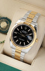 Angled view of Rolex Datejust 41 126333 with black index dial and 18k yellow gold fluted bezel