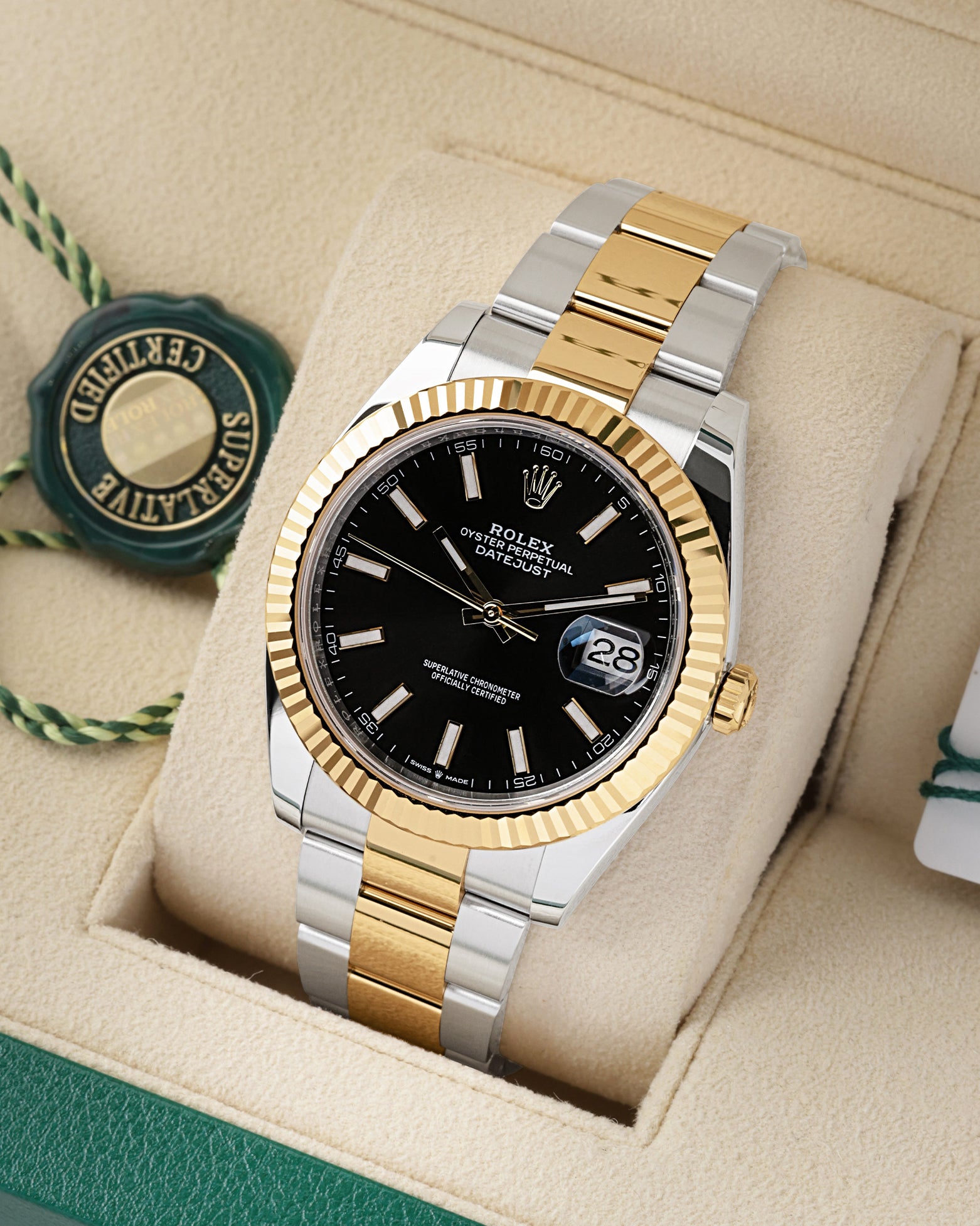Angled view of Rolex Datejust 41 126333 with black index dial and 18k yellow gold fluted bezel