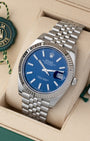 Angled view of Rolex Datejust 41 126334 featuring bright blue dial, fluted white gold bezel, and green tag